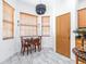 Bright breakfast nook with a wooden table set and pendant lighting fixture at 733 Seminole Blvd, Tarpon Springs, FL 34689