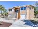 Beautiful house with a grand staircase leading to the entrance and attached garages at 733 Seminole Blvd, Tarpon Springs, FL 34689