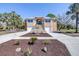 Stunning two-story home featuring a grand entrance, two garages, and beautiful landscaping at 733 Seminole Blvd, Tarpon Springs, FL 34689