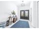 Bright and stylish foyer with decorative double doors, and modern lighting at 733 Seminole Blvd, Tarpon Springs, FL 34689