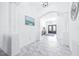 Spacious hallway with an arched entrance and a glimpse of the elegant double door at 733 Seminole Blvd, Tarpon Springs, FL 34689