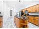 Beautiful kitchen with granite countertops and center island with shelving at 733 Seminole Blvd, Tarpon Springs, FL 34689
