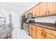 Kitchen features stainless steel appliances, wooden cabinets and granite countertops at 733 Seminole Blvd, Tarpon Springs, FL 34689