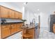 Kitchen featuring granite countertops and center island with shelving and sink at 733 Seminole Blvd, Tarpon Springs, FL 34689