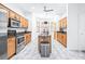 Bright kitchen with stainless steel appliances, wooden cabinets, and center island at 733 Seminole Blvd, Tarpon Springs, FL 34689