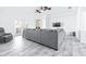 Spacious living room featuring tile floors, ceiling fan and an oversized gray couch at 733 Seminole Blvd, Tarpon Springs, FL 34689