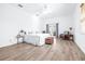 Bright main bedroom featuring wood floors, French doors, and neutral colors at 733 Seminole Blvd, Tarpon Springs, FL 34689