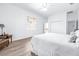 Bright main bedroom with wood-look floors, a view to the backyard, and neutral decor at 733 Seminole Blvd, Tarpon Springs, FL 34689