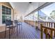Spacious wooden patio with ceiling fan, ideal for outdoor seating and enjoying the serene views at 733 Seminole Blvd, Tarpon Springs, FL 34689
