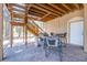 Brick patio with stairs, grill, and outdoor seating beneath wood staircase, ideal for entertaining at 733 Seminole Blvd, Tarpon Springs, FL 34689