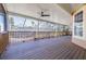 Expansive screened patio with wooden floors and ceiling fan, perfect for outdoor relaxation and dining at 733 Seminole Blvd, Tarpon Springs, FL 34689