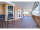 Covered wooden patio with windows and French doors, perfect for outdoor living and entertaining at 733 Seminole Blvd, Tarpon Springs, FL 34689