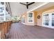 Large, covered wooden patio with ceiling fans, offering a relaxing outdoor living space at 733 Seminole Blvd, Tarpon Springs, FL 34689