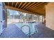 Screened in pool area with brick deck, perfect for relaxation and enjoying the serene outdoor space at 733 Seminole Blvd, Tarpon Springs, FL 34689