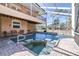 Inviting screened-in pool area with a spa, perfect for relaxing and enjoying the outdoors at 733 Seminole Blvd, Tarpon Springs, FL 34689