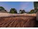 Expansive backyard with fresh soil and a wooden fence, ready for landscaping at 7505 Exter Way, Tampa, FL 33615