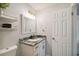 Modern bathroom with a granite countertop, stylish fixtures, and open shelving at 7505 Exter Way, Tampa, FL 33615