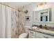 Bathroom with bright lights, marble-style shower tiles and gold finishes at 7505 Exter Way, Tampa, FL 33615