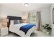 Bedroom with a dark headboard, patterned pillows, and bright natural light at 7505 Exter Way, Tampa, FL 33615