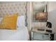 Elegant bedroom featuring a tufted headboard, mirrored nightstand, and stylish decor at 7505 Exter Way, Tampa, FL 33615