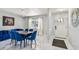 Elegant dining room featuring a modern chandelier and comfortable blue chairs at 7505 Exter Way, Tampa, FL 33615