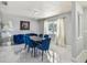 Bright dining room area with a crystal chandelier and view of the front yard at 7505 Exter Way, Tampa, FL 33615