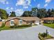 Single-story home with an attached garage, mature landscaping, and a spacious driveway at 7505 Exter Way, Tampa, FL 33615