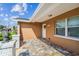 Charming front entrance with decorative lanterns, a white door, and colorful paver flooring at 7505 Exter Way, Tampa, FL 33615