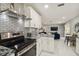 Modern kitchen with stainless steel appliances, sleek subway tile backsplash, and an open floor plan at 7505 Exter Way, Tampa, FL 33615