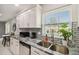 Updated kitchen features stainless appliances, granite counters, subway tile, and a view from the window at 7505 Exter Way, Tampa, FL 33615