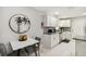Bright kitchenette featuring white cabinets, granite countertops, stainless steel appliances, and modern decor at 7505 Exter Way, Tampa, FL 33615