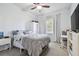 Bedroom with a ceiling fan, large window, light-colored walls, and neutral carpet providing a serene atmosphere at 7546 Dunbridge Dr, Odessa, FL 33556