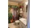 Bathroom showcasing a shower with a botanical-themed curtain, complemented by decorative greenery and floral arrangements at 8220 112Th St # 202, Seminole, FL 33772