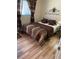Cozy bedroom features natural light, complementing the brown striped comforter, pillows, and decor at 8220 112Th St # 202, Seminole, FL 33772