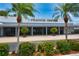 Exterior view of a commercial office building with landscaping and palm trees on a sunny day at 8220 112Th St # 202, Seminole, FL 33772