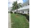 Exterior view of a condo building with well manicured landscaping and trees at 8220 112Th St # 202, Seminole, FL 33772