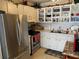 Functional kitchen with stainless steel appliances, ample storage, and decorative shelving at 8220 112Th St # 202, Seminole, FL 33772