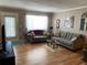Comfortable living room with gray sofas, hardwood floors, lots of light, and tasteful artwork at 8220 112Th St # 202, Seminole, FL 33772