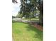 Scenic waterway view with lush green lawn and mature trees at 8220 112Th St # 202, Seminole, FL 33772