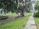 Scenic waterway view with walking path and lush green grass and trees at 8220 112Th St # 202, Seminole, FL 33772