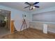 Bedroom with wood-look flooring and ceiling fan; ready for renovation and personalization at 9022 St Andrews Dr, Seminole, FL 33777