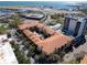 Aerial view showcases the property's layout with a central courtyard, pool, parking, and proximity to the water and airport at 100 4Th S Ave # 208, St Petersburg, FL 33701