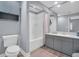 Clean bathroom with a tub shower, vanity and toilet at 100 4Th S Ave # 208, St Petersburg, FL 33701