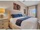 Serene bedroom featuring neutral tones, a comfortable bed, and a stylish desk area, with ample natural light at 100 4Th S Ave # 208, St Petersburg, FL 33701