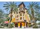 Beautifully designed condo building featuring balconies and a welcoming entrance, surrounded by palm trees at 100 4Th S Ave # 208, St Petersburg, FL 33701
