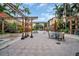 Expansive courtyard with shaded seating areas, manicured greenery, and charming architectural details at 100 4Th S Ave # 208, St Petersburg, FL 33701