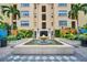 Elegant courtyard featuring a beautiful water fountain, lush landscaping, and an inviting entrance to the building at 100 4Th S Ave # 208, St Petersburg, FL 33701