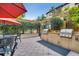 Outdoor grilling area featuring modern built-in grills, a dining set, and well-maintained landscaping for social events at 100 4Th S Ave # 208, St Petersburg, FL 33701