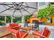 Inviting outdoor lounge area with comfortable seating, an umbrella, and a cozy fireplace, perfect for relaxing and entertaining at 100 4Th S Ave # 208, St Petersburg, FL 33701