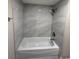 Clean bathroom showcases new gray tiling in the shower and lots of bright light from the overhead at 1000 49Th N St # 309, St Petersburg, FL 33710